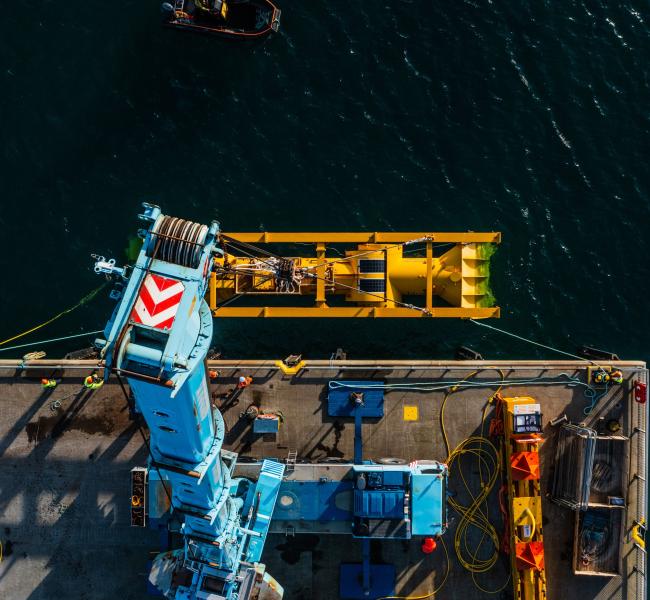 Mocean's Blue X being lowered into the water, aerial photo