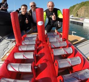 Bright red wave device with two sets of 7 small horizontal turbines 