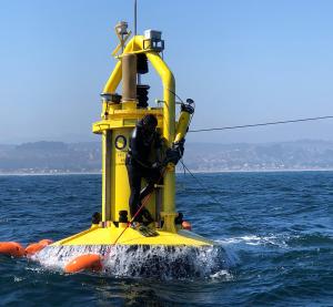 View of diver standing on the yellow PowerBuoy