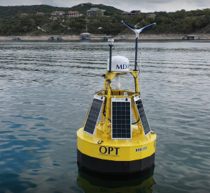 Close up view of yellow buoy WEC with solar and wind devices attached